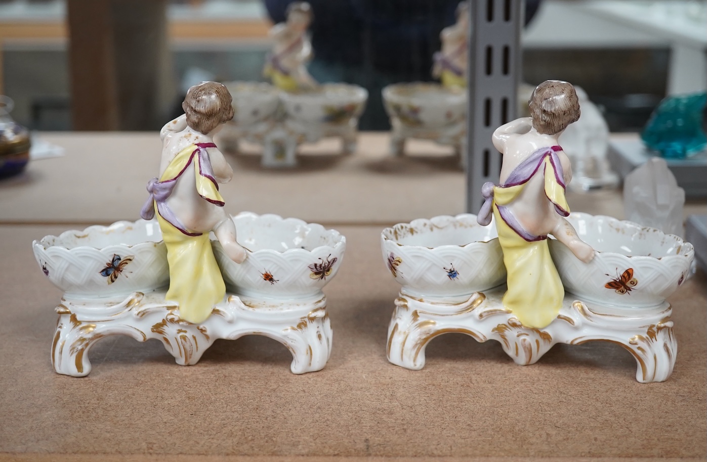 A pair of Berlin figural porcelain salts, hand painted with birds, 13.5cm wide. Condition - fair to good